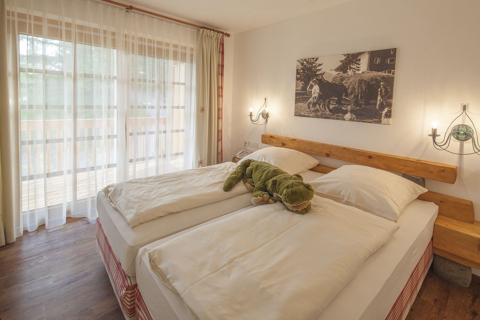 Kinderhotel Allgäuer Berghof – Schlafzimmer Familiensuite Chalet-Wohnung Edelweiss mit Blick auf die Allgäuer Alpen