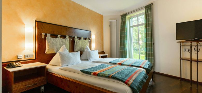 Schlafbereich in der Juniorsuite Südseeperle in NeptunsReich