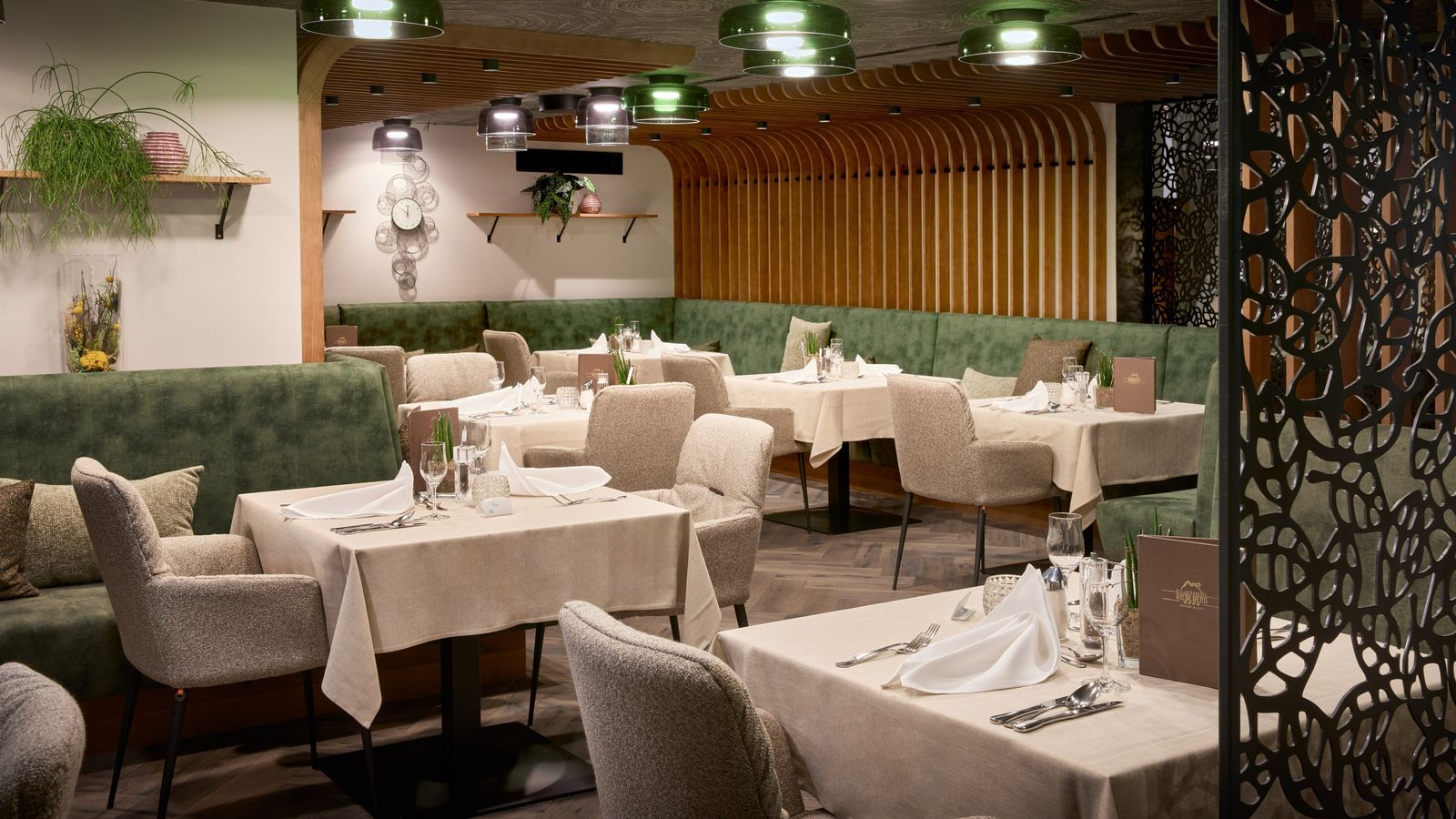 Restaurant Waldfee, tables laid with cloth napkins, beautiful atmosphere with wood paneling and decorations