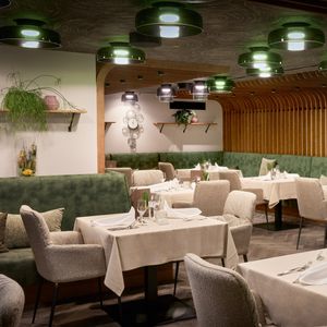 Restaurant Waldfee, tables laid with cloth napkins, beautiful atmosphere with wood paneling and decorations