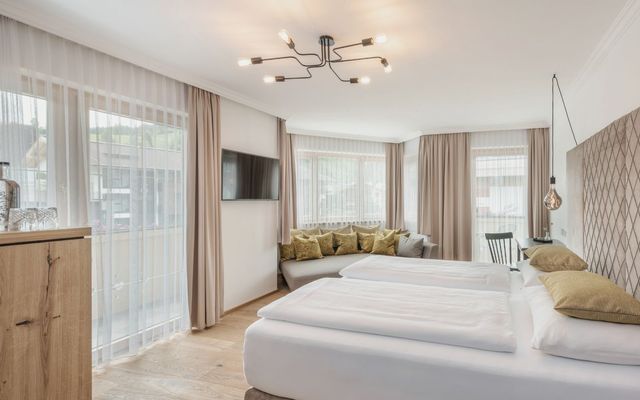 Helles, modernes Studio SÜDFLÜGEL im Hotel die HOCHKÖNIGIN in Maria Alm mit großen Fenstern, eleganter Einrichtung und stilvollen Details.